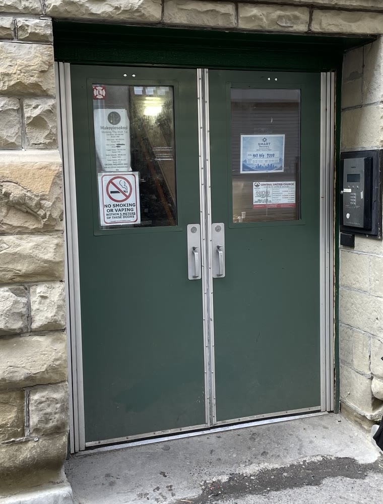 Green double-door meeting entrance in the back alley behind Central United Church
